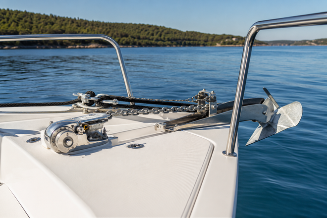 Boat anchor, chain and rope rode secured at the bow of a recreational boat